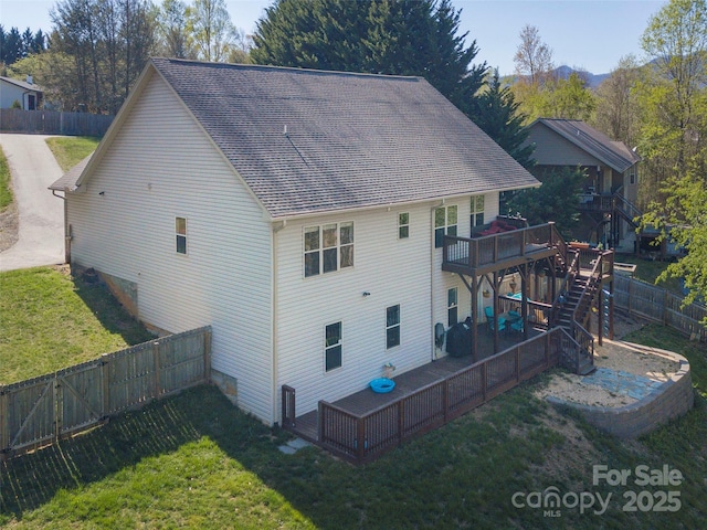 18 Birdsong Ln, Candler, NC 28715 - rear view of house featuring a fenced backyard, stairway, a lawn, a shingled roof, and a deck