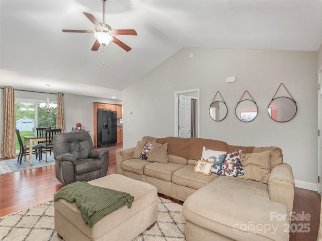 living room featuring high vaulted ceiling, light wood-style flooring, and ceiling fan with notable chandelier