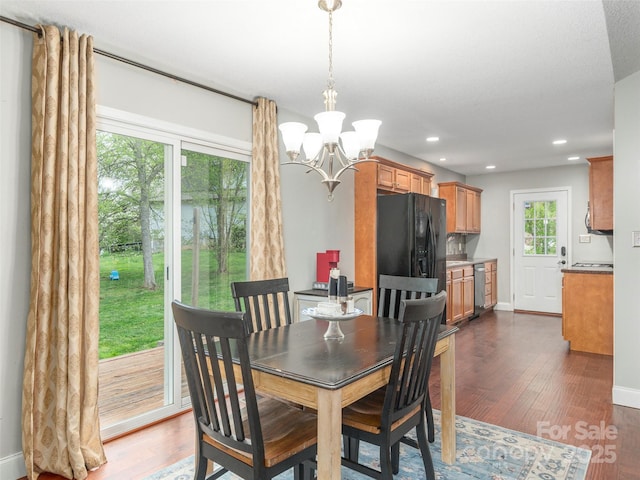 dining area featuring recessed lighting, dark wood-type flooring, baseboards, and an inviting chandelier
