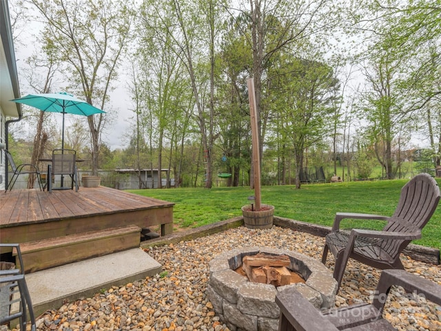 view of yard with an outdoor fire pit and a wooden deck