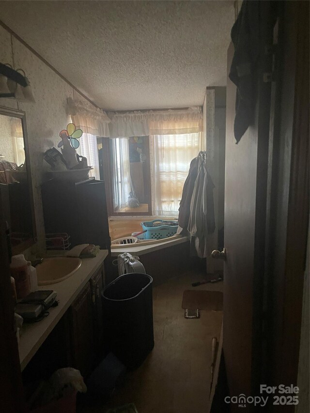 433 E Geroid St, Salisbury, NC 28144 - bathroom with a textured ceiling, vanity, and a shower