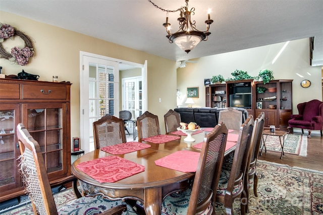 dining room featuring a notable chandelier and wood finished floors