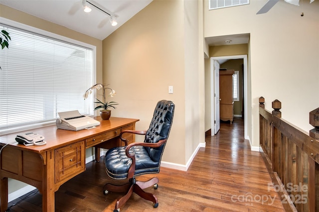 home office with visible vents, baseboards, ceiling fan, and hardwood / wood-style floors