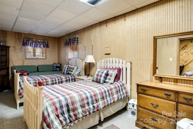 carpeted bedroom with a paneled ceiling