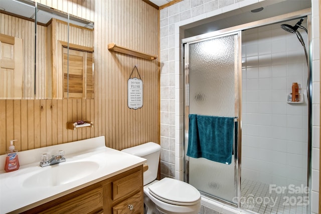 bathroom featuring toilet, a shower stall, and vanity
