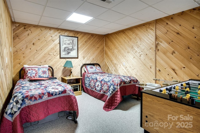 carpeted bedroom with a drop ceiling