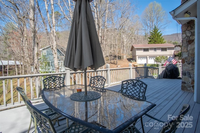 wooden deck featuring outdoor dining area