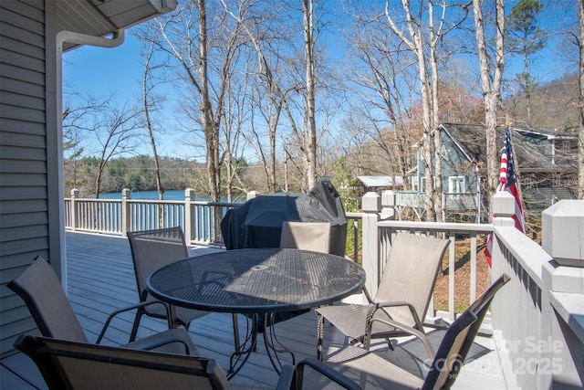 wooden terrace featuring outdoor dining space