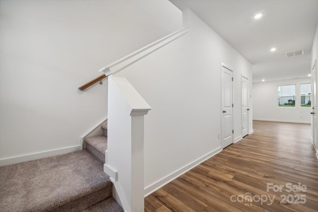 staircase with recessed lighting, visible vents, baseboards, and wood finished floors