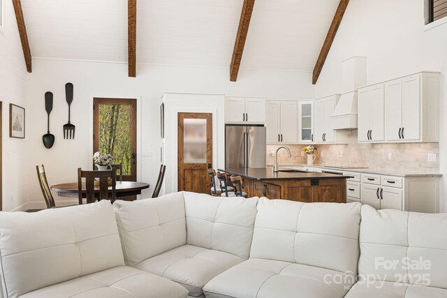 living area with vaulted ceiling with beams
