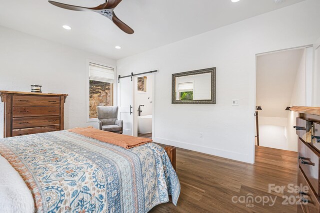 bedroom featuring wood finished floors, a barn door, recessed lighting, ceiling fan, and baseboards