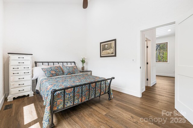 bedroom with wood finished floors, a ceiling fan, visible vents, baseboards, and recessed lighting