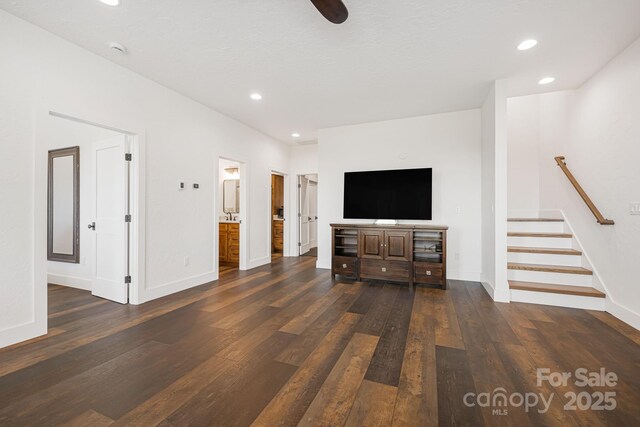 unfurnished living room with baseboards, recessed lighting, and dark wood-style floors