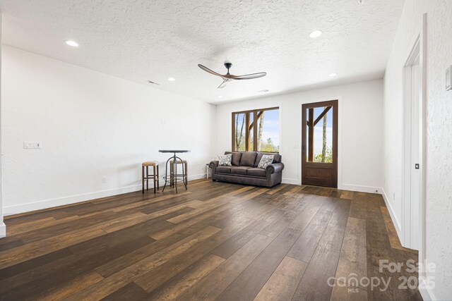 sitting room featuring a textured ceiling, dark wood-type flooring, ceiling fan, and recessed lighting