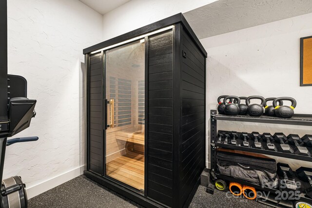interior space with baseboards and a sauna