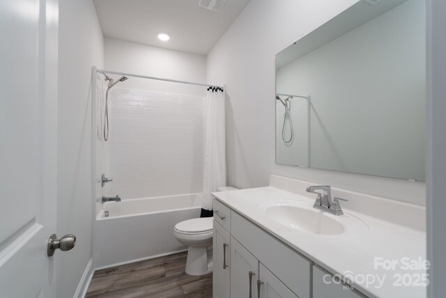 full bath with toilet, shower / bath combination with curtain, recessed lighting, wood finished floors, and vanity
