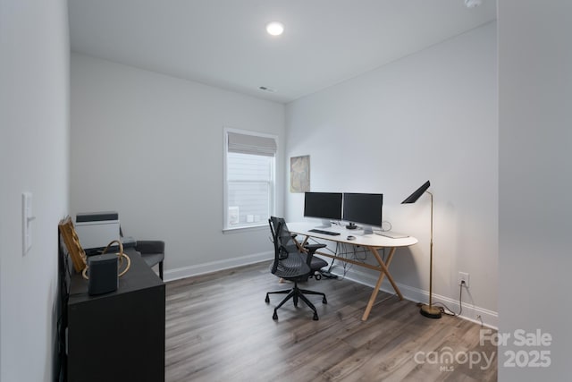 office area with visible vents, wood finished floors, and baseboards