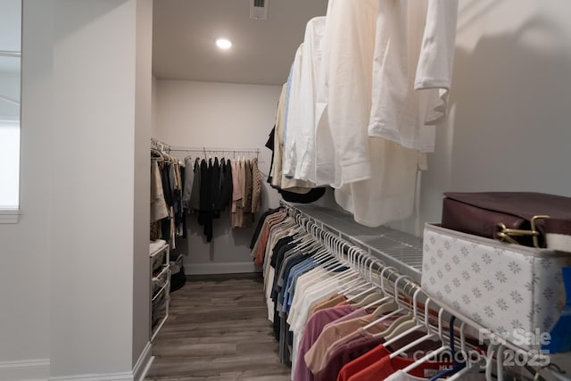 walk in closet with wood finished floors and visible vents