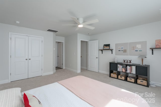 carpeted bedroom with a closet, visible vents, ceiling fan, and baseboards