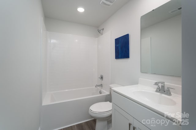 bathroom with vanity, toilet, visible vents, bathtub / shower combination, and wood finished floors