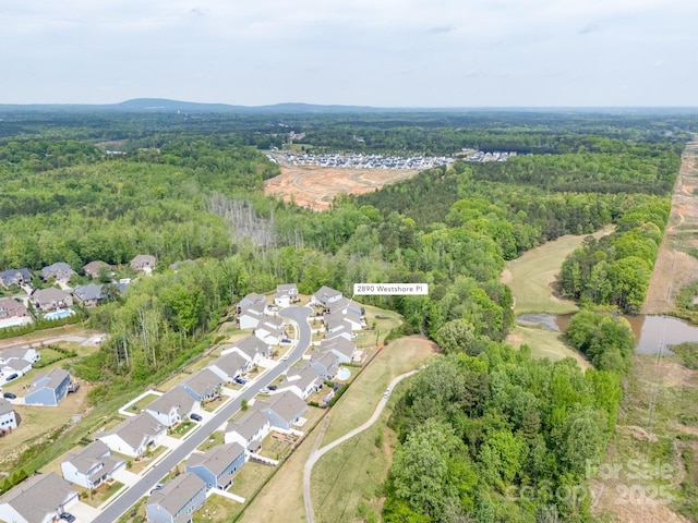 aerial view with a wooded view and a residential view