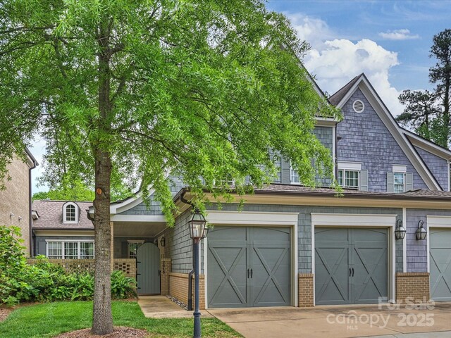 2616 Colton Dr, Charlotte, NC 28211 - townhome / multi-family property featuring an attached garage, concrete driveway, and brick siding