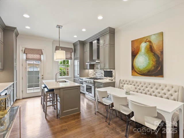 2616 Colton Dr, Charlotte, NC 28211 - kitchen featuring wall chimney exhaust hood, a sink, stainless steel stove, crown molding, and gray cabinetry