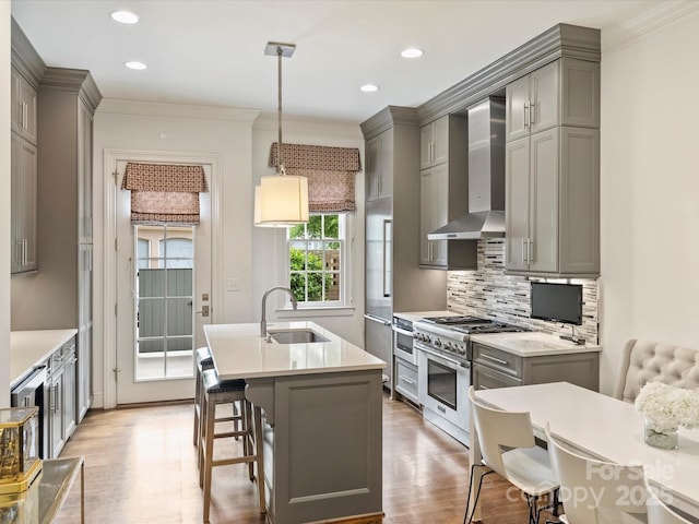 2616 Colton Dr, Charlotte, NC 28211 - kitchen with wall chimney range hood, gray cabinetry, light wood-type flooring, and high end appliances