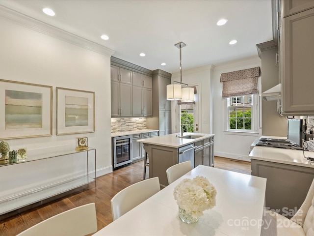 2616 Colton Dr, Charlotte, NC 28211 - kitchen with ornamental molding, gray cabinetry, a center island with sink, wine cooler, and range hood