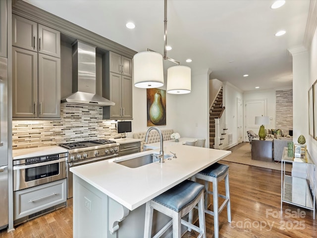 2616 Colton Dr, Charlotte, NC 28211 - kitchen featuring tasteful backsplash, wall chimney range hood, open floor plan, stainless steel appliances, and a sink