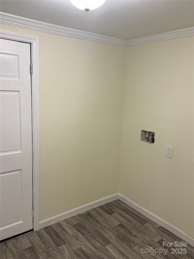 spare room with dark wood-style flooring, baseboards, and ornamental molding