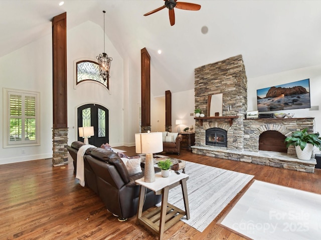 633 Elmhurst Dr, Fort Mill, SC 29715 - living room with a fireplace, high vaulted ceiling, wood finished floors, a ceiling fan, and a chandelier