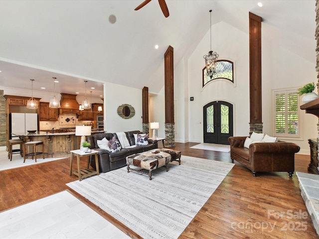 633 Elmhurst Dr, Fort Mill, SC 29715 - living area featuring high vaulted ceiling, decorative columns, wood finished floors, ceiling fan, and french doors