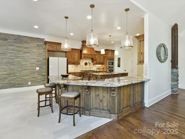 633 Elmhurst Dr, Fort Mill, SC 29715 - kitchen featuring custom range hood, a large island, a kitchen breakfast bar, appliances with stainless steel finishes, and baseboards