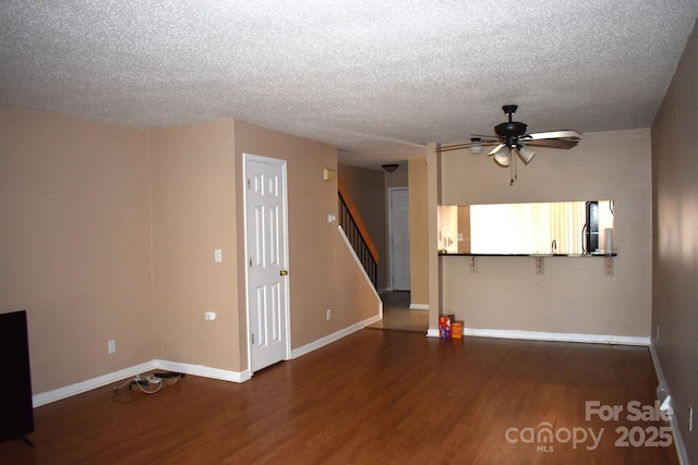 331 Eastwood Dr, Salisbury, NC 28146 - unfurnished living room featuring stairway, ceiling fan, baseboards, and wood finished floors