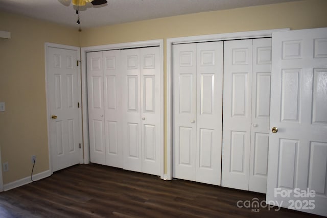 331 Eastwood Dr, Salisbury, NC 28146 - unfurnished bedroom with baseboards, two closets, and dark wood-style floors