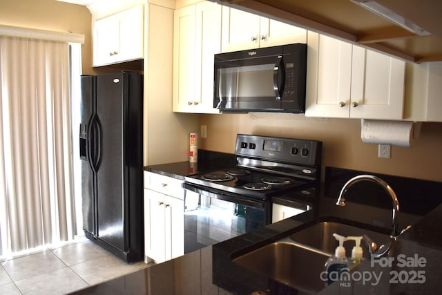 331 Eastwood Dr, Salisbury, NC 28146 - kitchen featuring white cabinetry, black appliances, light tile patterned flooring, a sink, and dark countertops
