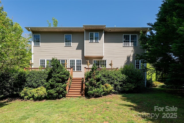 rear view of house featuring stairs, a yard, and a deck