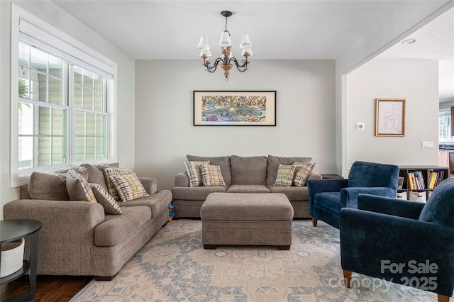living area featuring a chandelier and light wood finished floors