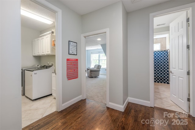 hallway with wood finished floors and baseboards