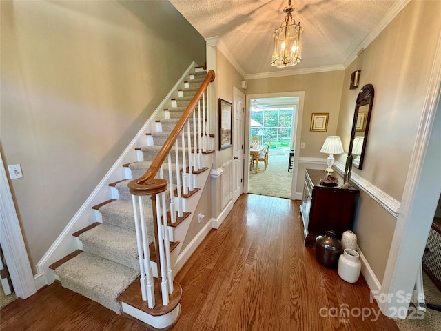 271 Ikerd Dr SE, Concord, NC 28025 - entryway with stairs, a notable chandelier, a textured ceiling, and wood finished floors