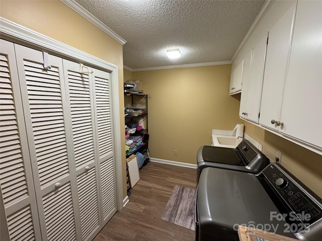 271 Ikerd Dr SE, Concord, NC 28025 - washroom with baseboards, dark wood-type flooring, a textured ceiling, cabinet space, and washer and clothes dryer