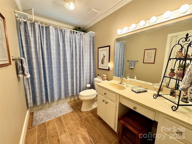 271 Ikerd Dr SE, Concord, NC 28025 - full bathroom featuring visible vents, toilet, a textured ceiling, vanity, and wood finished floors