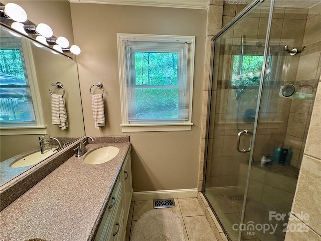 271 Ikerd Dr SE, Concord, NC 28025 - bathroom featuring tile patterned floors, a shower stall, vanity, and a wealth of natural light