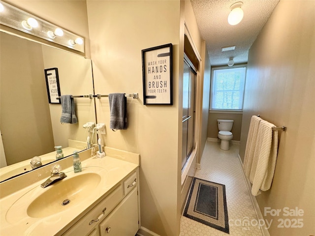 271 Ikerd Dr SE, Concord, NC 28025 - full bath with a textured ceiling, vanity, a shower with door, toilet, and baseboards