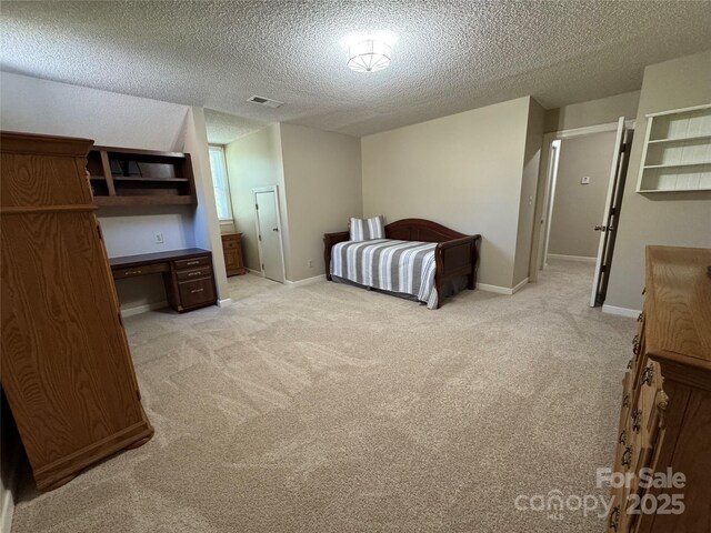 271 Ikerd Dr SE, Concord, NC 28025 - bedroom with visible vents, baseboards, light colored carpet, and a textured ceiling