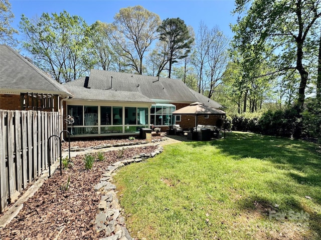 271 Ikerd Dr SE, Concord, NC 28025 - rear view of property featuring fence, a patio area, an outdoor hangout area, a sunroom, and a lawn