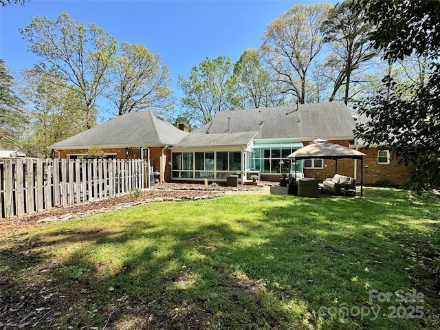 271 Ikerd Dr SE, Concord, NC 28025 - rear view of house with an outdoor living space, a yard, fence, and a sunroom
