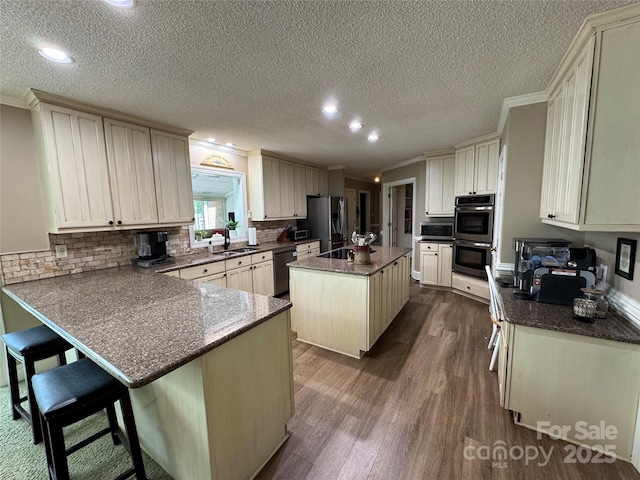 271 Ikerd Dr SE, Concord, NC 28025 - kitchen featuring recessed lighting, a peninsula, dark wood-style floors, a textured ceiling, and stainless steel appliances