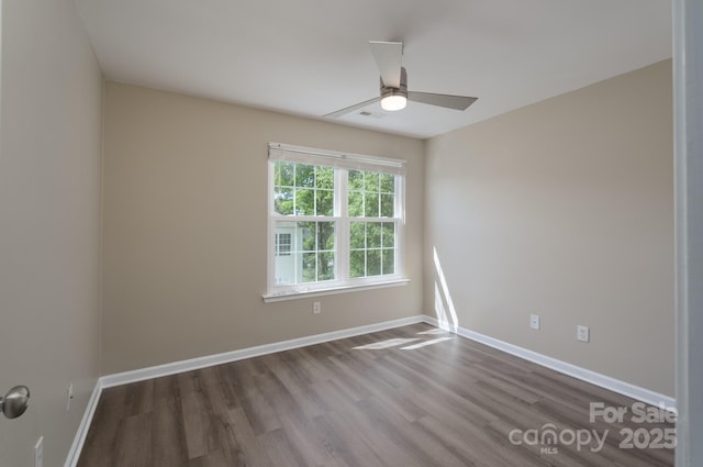 empty room with baseboards, a ceiling fan, and wood finished floors
